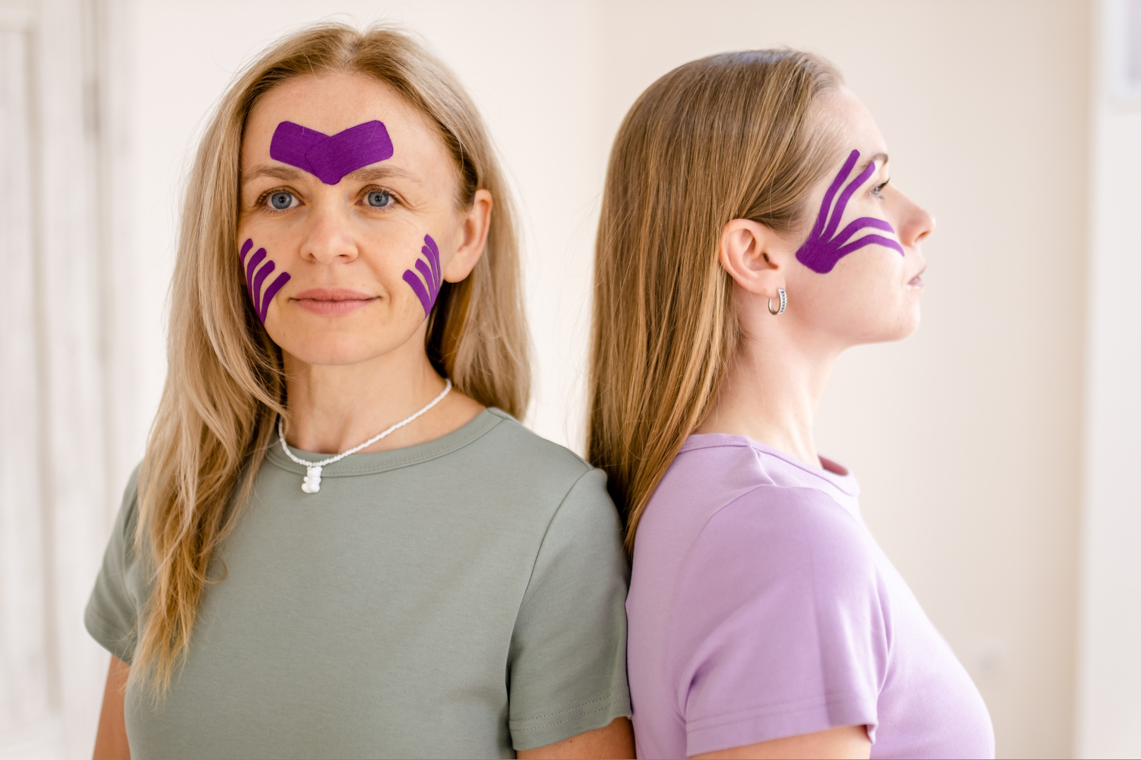 women 30 -40 years old with kinesio tape on face. Kinesiotaping for face,rejuvenation